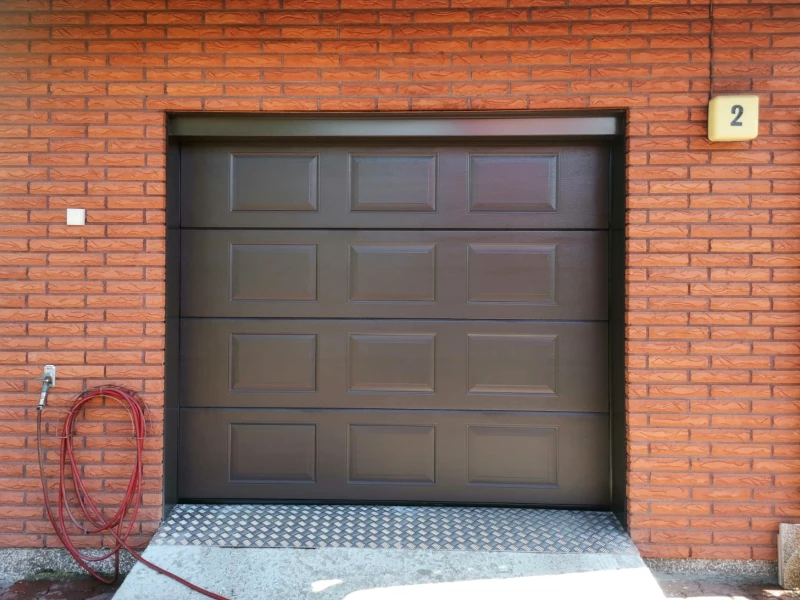 Autotallin nosto-ovi asennettuna Lahdessa turkkipeltikynnys ja peltipielet peilikuvio — JK-Ovet