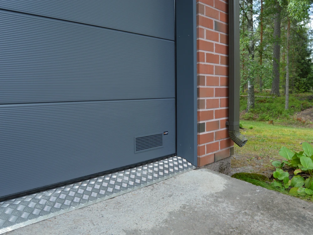 Autotallin nosto-ovi asennettuna Myllykoskella Kouvolassa — mikroura sileällä pinnalla — JK-Ovet